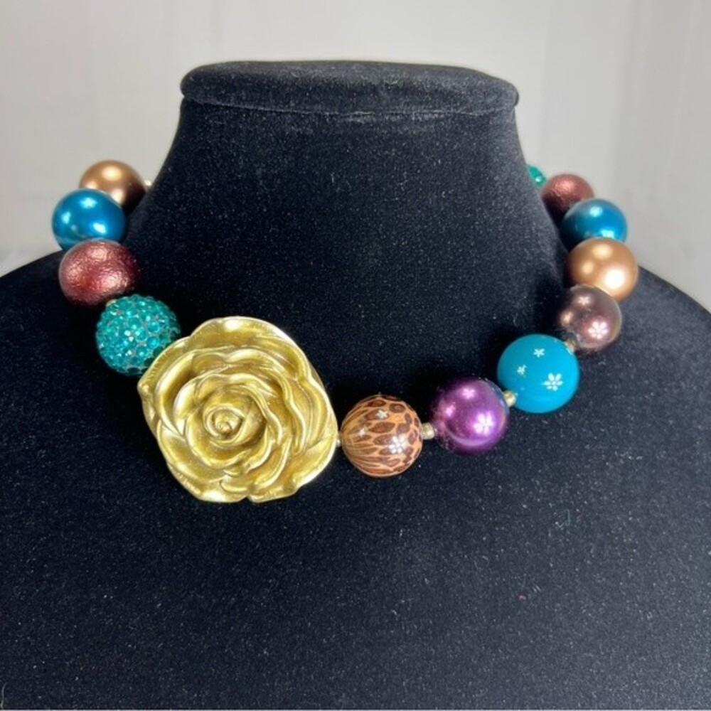 Large faux pearl necklace with gold flower focal point